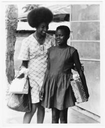 Woman and Child Carrying Packages, circa 1972