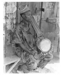 Unidentified Man Sitting With a Drum, circa 1972