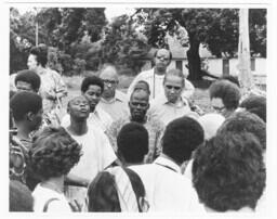 An Unidentified Man at the Center of a Circle Speaks, circa 1972