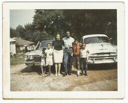 A Family Standing in Front of Cars, September 4, 1967