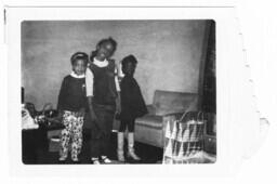 Three Girls Stand in a Living Room, circa 1961