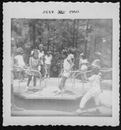 Children Play on a Merry-Go-Round, circa 1960