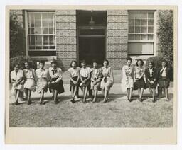 A Group Portrait of Twelve Unidentified Women on Benches, circa 1960