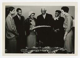 A Group of Men and Women at an African Art Display, circa 1960