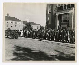 A Procession of Graduates at Entrance of Building at Commencement, circa 1965