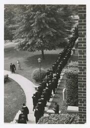 A Procession of Graduates at Entrance of Building at Commencement, circa 1965