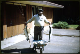 C. Eric Lincoln Holding Fish, circa 1980