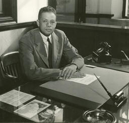 John H. Wheeler Sitting at His Desk, circa 1955