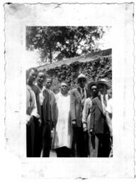 Group of Men Stand in Front of a Wall, circa 1942