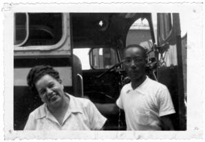 A Woman and a Man Stand Outside of a Bus, circa 1950