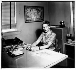 Grace Towns Hamilton Sitting Behind a Desk, circa 1950