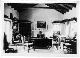 A Man Reads in Front of a Fireplace, circa 1920