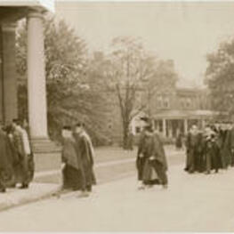 A line of faculty, students, and staff from the Atlanta University Center form a procession before the dedication of the Trevor Arnett Library. Written on verso: Speakers and guests of honor entering Sisters Chapel on Spelman campus on library dedication day. The exercises were held in this chapel instead of on the campus adjoining the library on account of a drenching rain that fell all Saturday morning