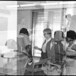 C. Eric Lincoln talks with students in a classroom (double exposure).