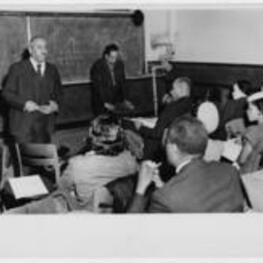Langston Hughes and Arna Bontemps give a lecture. Written on verso: Langston Hughes to right facing group Atlanta University - March 28, 1947, Also - Arna Bontemps of Fisk