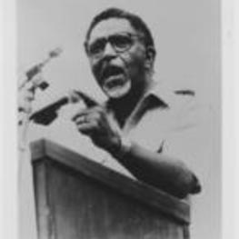 Joseph E. Lowery speaking at a podium and pointing with his left hand.
