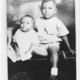 A portrait photo of Joseph E. Lowery as a toddler, sitting on a toy truck with an unidentified baby.