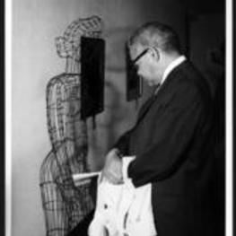 Dr. Bond looks at a sculpture titled "Woman with Brassier".