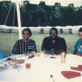 C. Eric Lincoln sits at a table with other guests at Alex Haley's house in Tennessee.