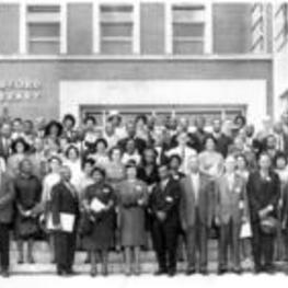 A group portrait of the College Language Association outside Bluford Library.
