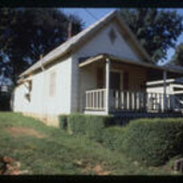An angled view of a shotgun house. Text from slide presentation: One of the most prominent features of a shotgun house, and almost any historic southern house, is the porch.
