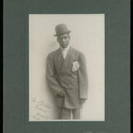 Portrait addressed to "Billie" from Cookie standing in suit with a cane. Cookie of the William and Walker Company.