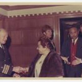 Virginia L. Jones and Edward A. Jones shake hands with others.