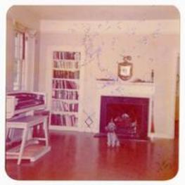 Pet dog near fireplace. Written on verso: President John Kennedy's son was in women's dormitory for freshmen. Guidance the last year they residents of Mass. Ted accepted a sabbatical leave till they established residence at Portland [?].