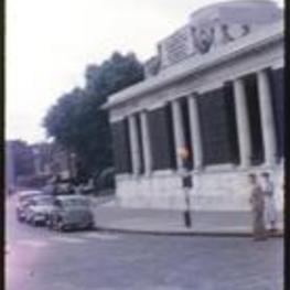 An unidentified building with columns on a street corner.
