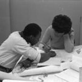 An unidentified woman and man review maps in a VEP office.