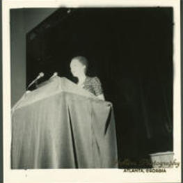 An unidentified woman delivering a speech during the 1974 "Henderson, We Love you Madly Day" Celebration.