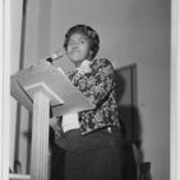 Dorothy Bolden speaks from a lectern. Written on verso: Mrs. Dorothy Bolden, National President of Domestic Workers, 643 Delbridge Street N. W., Atlanta, Georgia 30314.