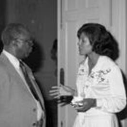 Vivian Malone Jones talks with an unidentified man at an event.