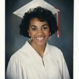 Portrait of Kimberly Floyd wearing graduation regalia.