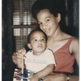 Ruby D. Smith Robinson is holds her son, Kenneth Toure Robinson, while he plays with a toy xylophone.