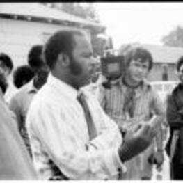 John R. Lewis speaks to a group of people during a voting rights tour.