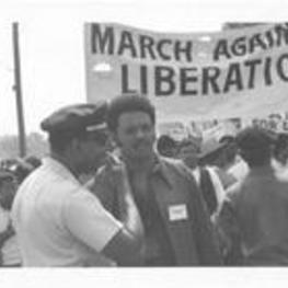 Jesse Jackson speaks with Captain Howard Baush at the March Against Repression. Written on accompanying document: SCLC's Jesse Jackson talks with Capt. Howard Baush.