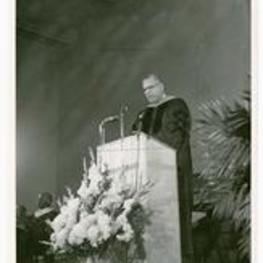 Martin Luther King, Sr. delivers a speech at a podium.