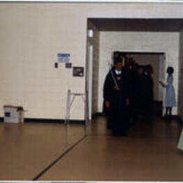Graduates enter a gymnasium for their graduation ceremony. Written on recto: Procession of Class of 1978.