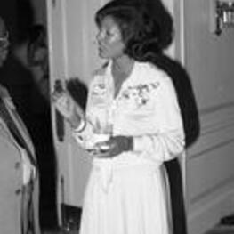 Vivian Malone Jones talks with an unidentified man at an event.