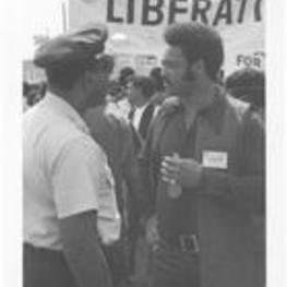 Jesse Jackson speaks with Captain Howard Baush at the March Against Repression. Written on accompanying document: SCLC's Jesse Jackson talks with Capt. Howard Baush.