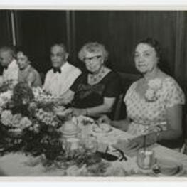 Elenor Roosevelt, Rufus Clement and others seated at a banquet table. Written on verso: Love Mother, 6/4/62, Mother on Mrs. Roosevelt's left.