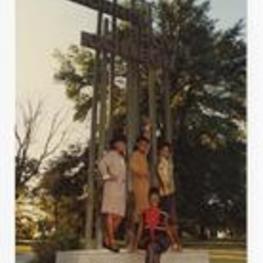Outdoor group portrait of four women standing on sculpture sign "Morris Brown College".