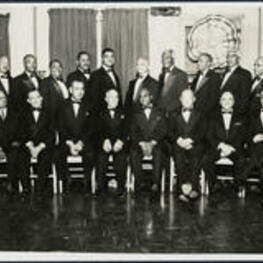 A group portrait of members of the Sigma Pi Phi Fraternity. Extraneous note: Dr. Rufus Clement (seated 1st from right), [?] Hackney (standing 3rd from left), Whitney Young (standing 5th from left), J. B. Blayton (standing 3rd from right), [?] Milton (standing 1st from right), A. T. Walden (seated 3rd from right), B. R. Brazeal (seated 3rd from left), Clarence Baycote (standing 4th from left), Albert Manley (standing 5th from right), Benjamin E. Mays (standing 4th from right), James Brawley (seated 4th from right).