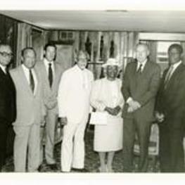 Written on verso: Brunch at home of the President Gloster on Commencement Day, May 19, 1985: L. to R.: Mayor Coleman Young, President Gloster, Mr. Lawrence Small, Dr. Thomas Kilgore Jr, Mrs. Kilgore, Mr. Walter Wriston, and Mr. Sidney Poitier.
