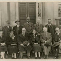 Group photographed outside the Trevor Arnett Library during its dedication. Pictured are (top row, left to right) Trevor Arnett, an unidentified man, Benjamin E. Mays, and unidentified man, Rufus E. Clement, (bottom row, left to right) an unidentified woman, Mrs. Trevor Arnett, an unidentified man, Florence M. Read, Kendall Weisiger, and an unidentified man. Written on verso: Dedication library building. Last man on left on back row may be Trevor Arnett, bottom row, second from left, Mrs. Trevor Arnett?, 4th from left, Mrs. Florence M. Read. First from left, Mr. Trevor Arnett [?], third from left, Dr. Benjamin Mays, last, Dr. Rufus Clement