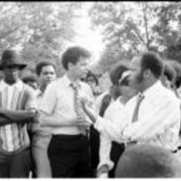 John R. Lewis and Julian Bond speak to a group of people during a voting rights tour.