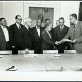 Brailsford R. Brazeal shakes hands with Charles H. Haynes in a group presentation from the Morehouse College Alumni Association.