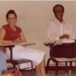 Dr. Elynor Brown, Professor Carol Miller, and Dr. Abe Davis sit in classroom chairs.