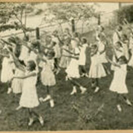 Students perform a synchronized dance outside.